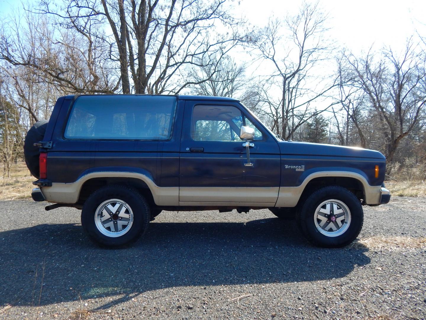 1988 Blue /Tan Ford Bronco II 4WD (1FMCU14T6JU) with an 2.9L V6 OHV 12V engine, 4-Speed Automatic Overdrive transmission, located at 6528 Lower York Road, New Hope, PA, 18938, (215) 862-9555, 40.358707, -74.977882 - Here we have a 1988 Ford Bronco 2 with a 2.9L V6 putting power to a 4x4 automatic transmission. Options include: tan cloth interior, heat/AC, XD Vision radio, power windows, cruise control, tilt steering wheel, front/rear defrost windows, spare tire cover, 15 inch alloy wheels with 4 Solarus AP tire - Photo#18